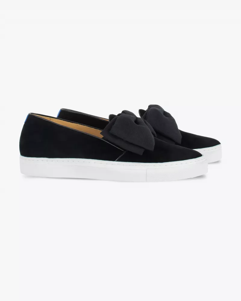 Black suede slip-ons with oversize bow