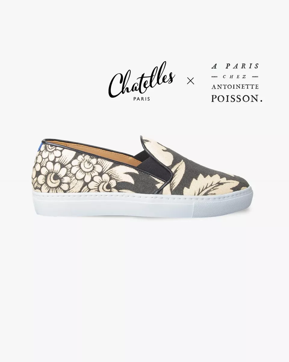 Canvas slip-ons with a pattern of large Black and Cream poppies