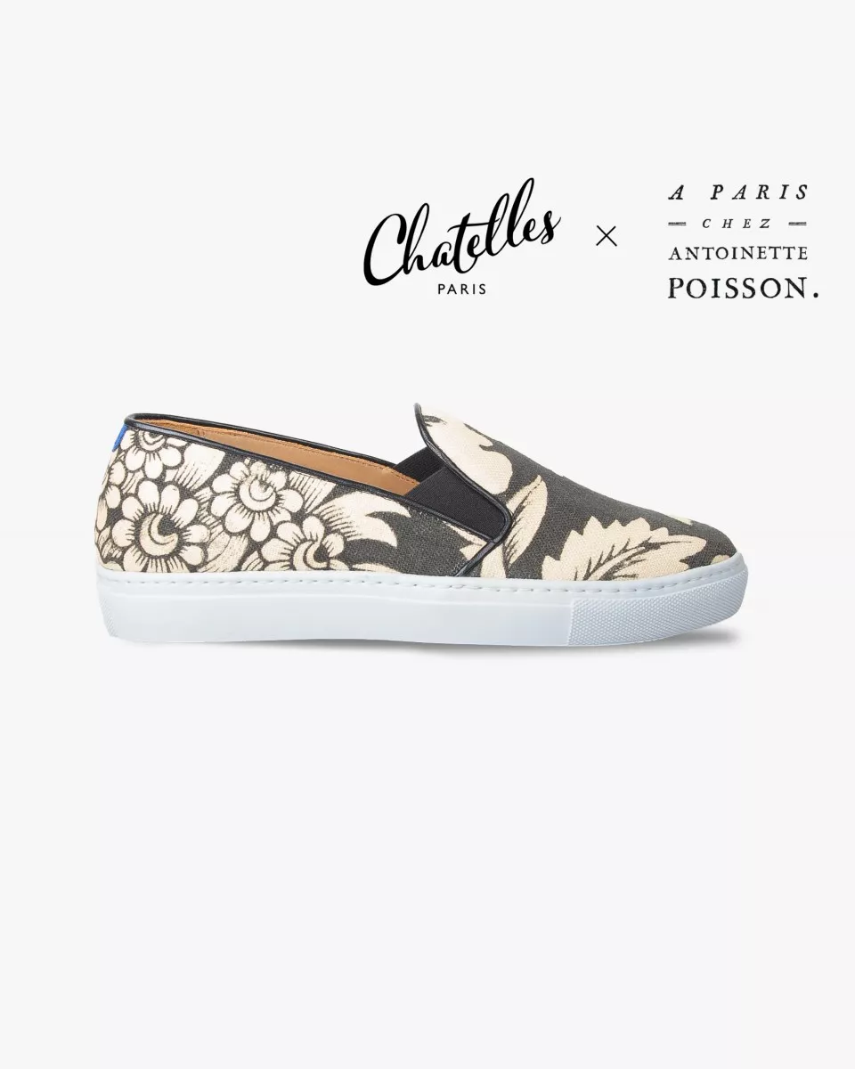 Canvas slip-ons with a pattern of large Black and Cream poppies