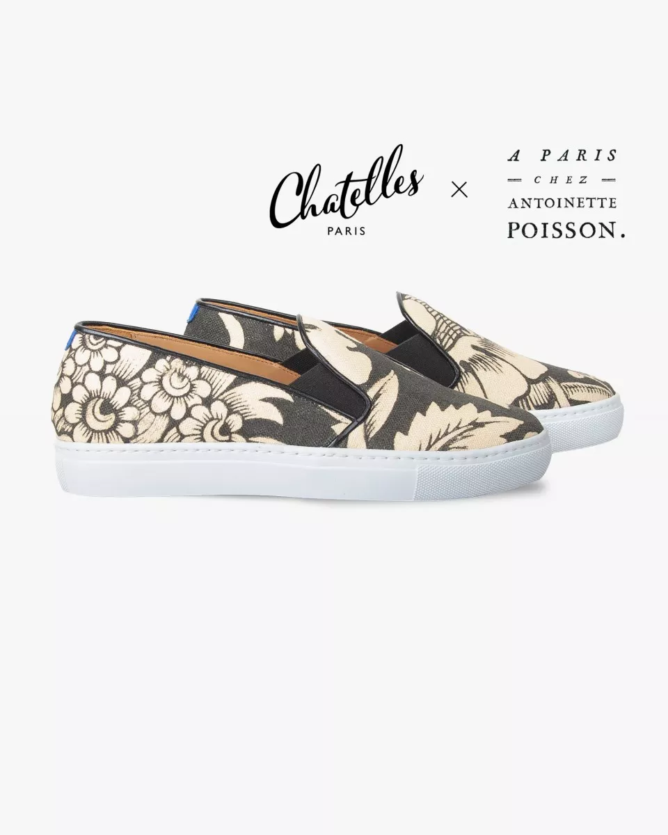Canvas slip-ons with a pattern of large Black and Cream poppies