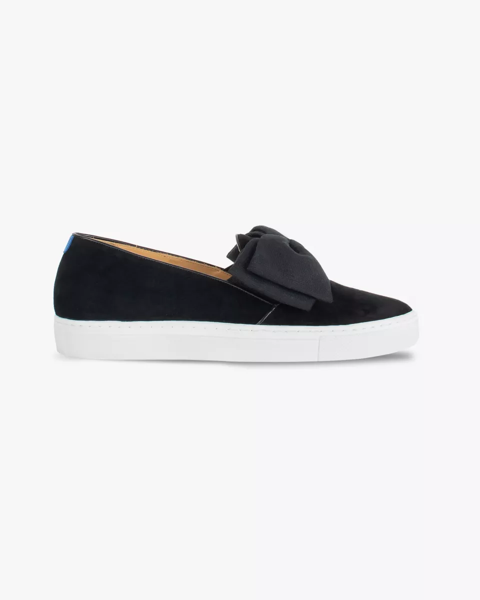Black suede slip-ons with oversize bow