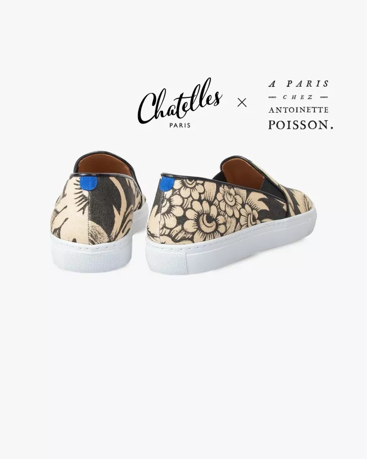 Canvas slip-ons with a pattern of large Black and Cream poppies