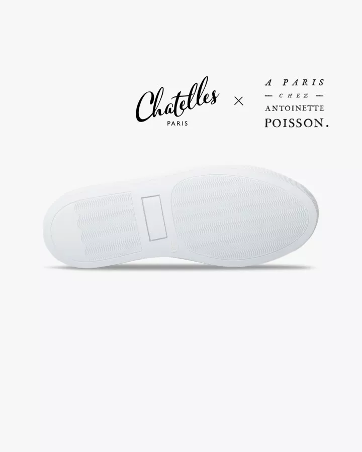 Canvas slip-ons with a pattern of large Black and Cream poppies