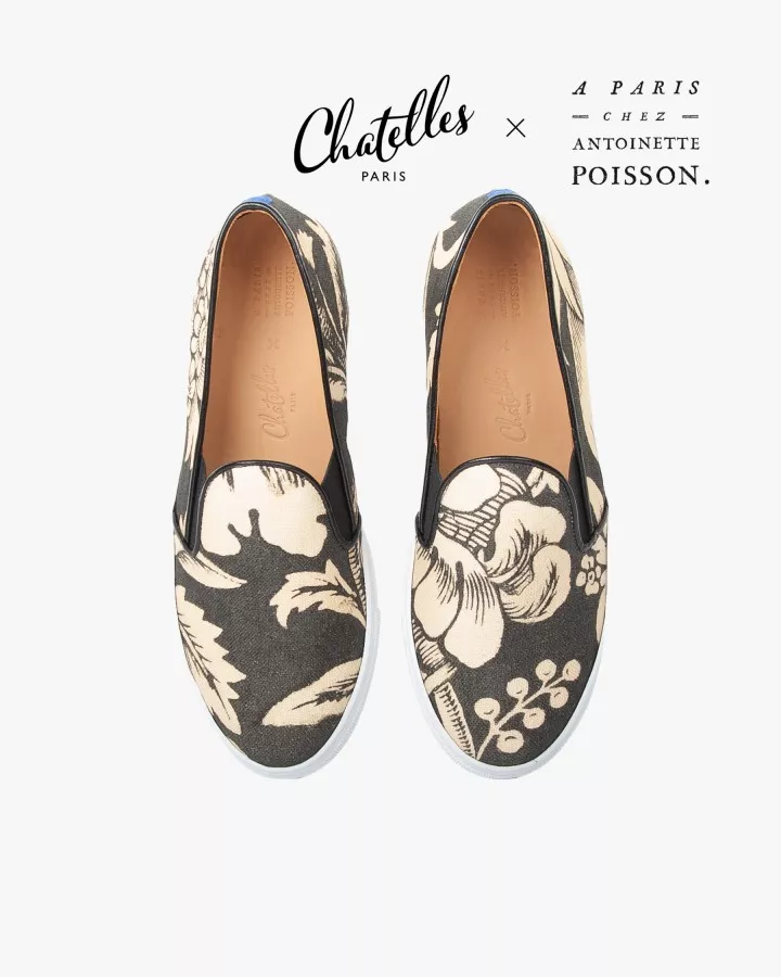 Canvas slip-ons with a pattern of large Black and Cream poppies