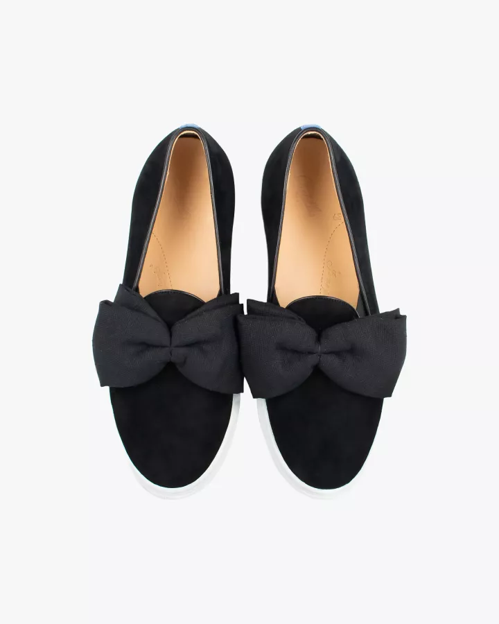 Black suede slip-ons with oversize bow